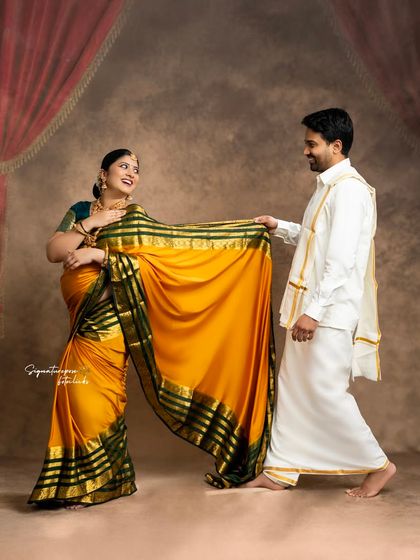 A playful and candid moment between the couple, showcasing their chemistry and traditional outfits.