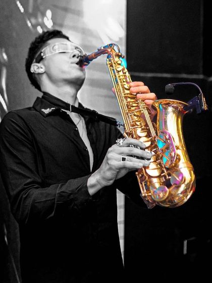 A saxophonist joins the party at Toca, adding a live element to the night.