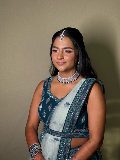 A candid side profile, her makeup looking flawless and her expression happy and relaxed.