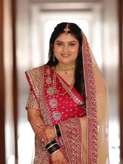 A beautiful portrait of the bride. The soft glam makeup and traditional red saree create a look that is both classic and stunning.