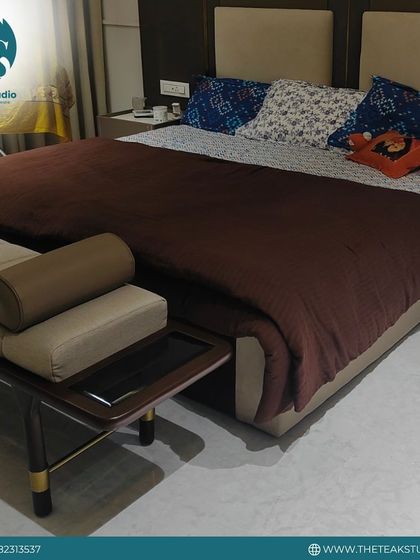 This simple yet elegant bedroom set includes a beige upholstered bed and a dark wood end-of-bed bench with a matching cushion.