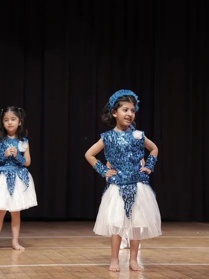 Striking a confident pose, this 'Dancing Rocket' shows off her stage attitude. We help every child find their inner performer.