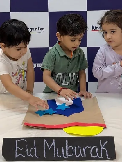 Children working together on an Eid Mubarak craft project. Collaborative activities like this are a big part of our party philosophy.