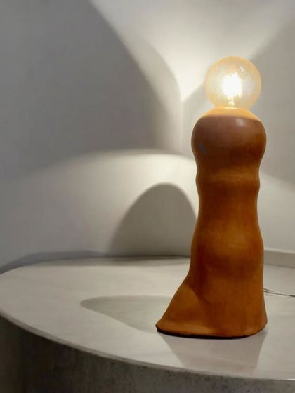 Illuminate your space with this contemporary ceramic lamp. Meticulously handcrafted, it is designed to create a warm, inviting atmosphere while serving as a stunning decorative element.