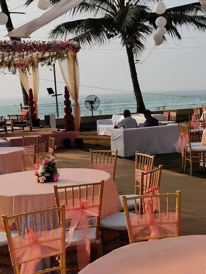 This photo captures the full scope of a pastel pink beach wedding setup. You can see the mandap, guest seating with round tables, and the beautiful ocean view that we incorporated into the design.