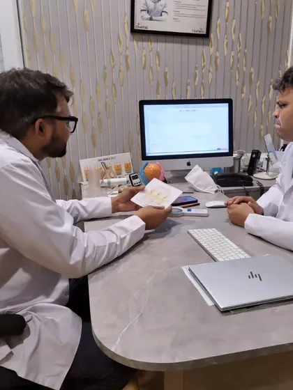 Collaboration is key to excellence. Here, I am discussing a patient's case with a fellow consultant dermatologist to ensure we are providing the most effective and suitable treatment plan.
