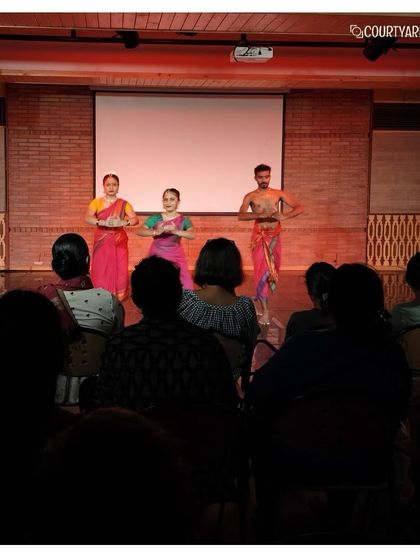 The artists from Attakkalari taking a bow after their performance, a moment of connection with the appreciative audience.