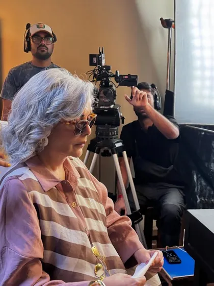 On set, making final adjustments for Zeenat Aman's look. This is where the magic happens, ensuring every detail of the outfit is perfect for the camera.