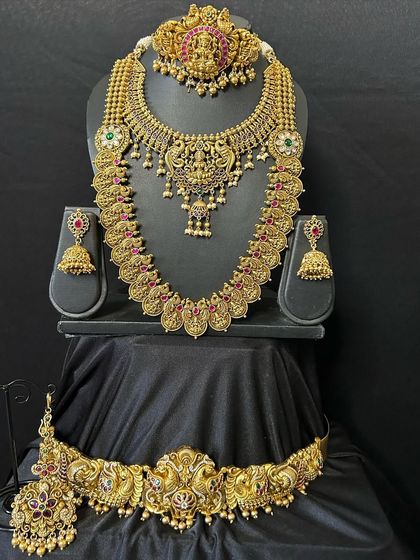 I offer a variety of combinations to suit your style. This set features a beautiful choker and a matching long haaram, both adorned with intricate carvings and kemp stones, paired with a detailed waist belt.