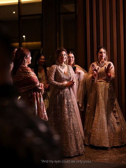 A candid moment of the bride with her friends. Her sparkling lehenga and happy smile show she's ready to celebrate her big day.