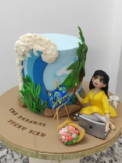 A cake for a workaholic wife who dreams of the sea. This design captures all her favorite things: a serene beach scene, a figurine of her painting Van Gogh's "Starry Night," her laptop, and a bouquet of flowers. It's a beautiful reminder to find balance.
