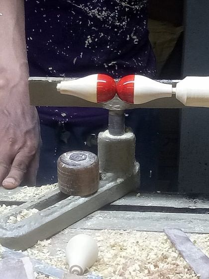 An artisan turns wood on a hand lathe, shaping a component for the Lucky Chan installation. It was a fascinating experience to visit the Channapatna township and witness this incredible skill firsthand.