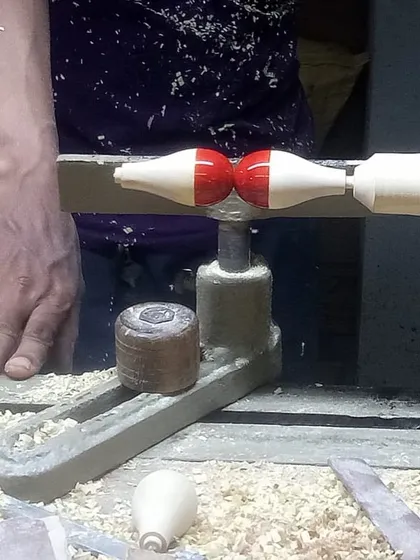 An artisan turns wood on a hand lathe, shaping a component for the Lucky Chan installation. It was a fascinating experience to visit the Channapatna township and witness this incredible skill firsthand.