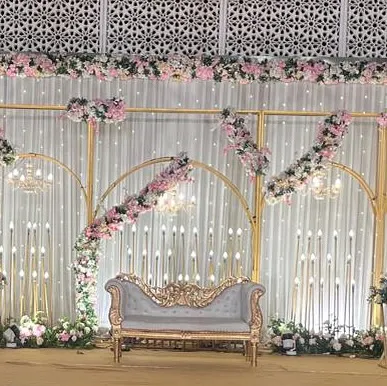The full view of the elegant stage with a classic sofa. The combination of modern arches and traditional florals creates a unique and beautiful design.
