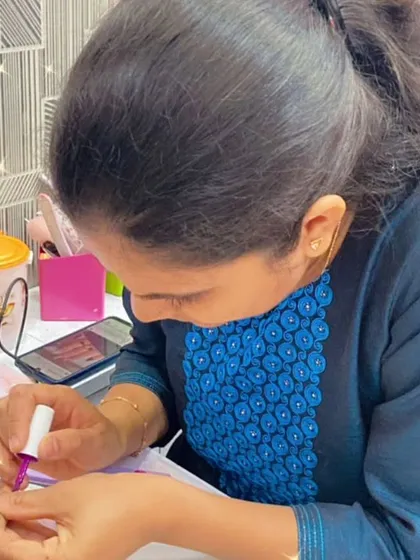 This student is learning how to apply gel polish, a fundamental skill for any modern nail technician.
