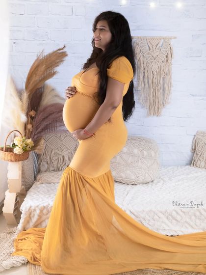 A beautiful boho-chic setup. The natural textures of the macrame, pampas grass, and white brick create a warm and inviting atmosphere.