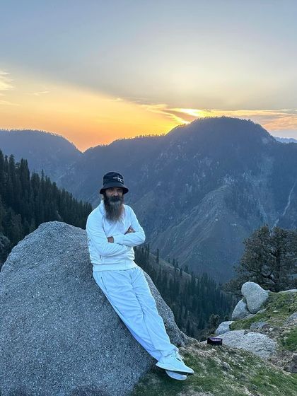 Leaning against a rock at sunset in the mountains. The end of the day is a time for reflection and gratitude for the beauty of the world.