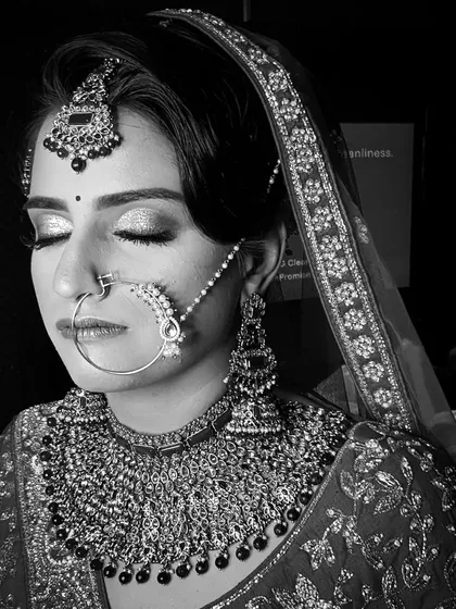 A timeless black and white portrait. This format emphasizes the structure, contour, and shimmer of the makeup, showing how well it photographs. The glitter on her eyes still shines through.