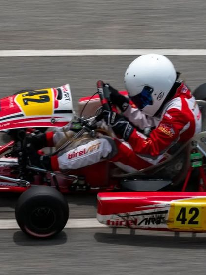 An aerial view of the number 42 kart at speed, showing the chassis dynamics and driver inputs during high-performance driving.