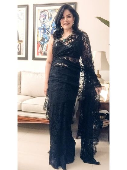 Another angle of the Chantilly lace saree, showcasing its beautiful drape and intricate texture. It's a classic piece that proves you can never go wrong with a black saree for a special occasion.