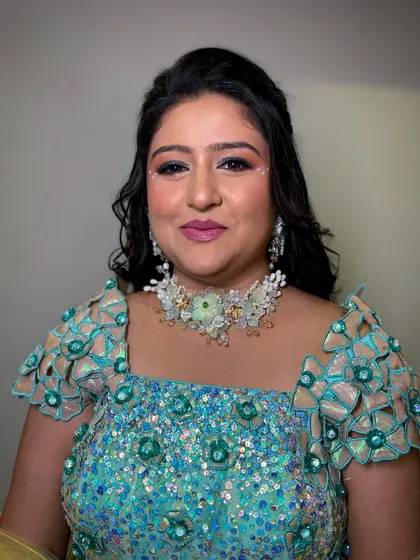 A smiling portrait of the bride, looking happy and ready for the festivities.