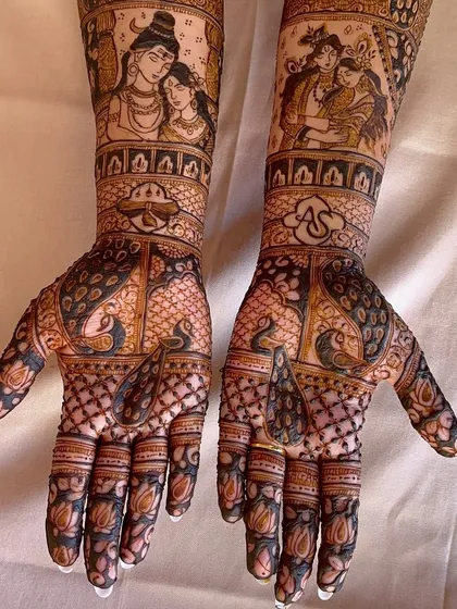 A close-up angle of the divine couple portraits, highlighting the shading and fine line work that bring the figures to life.