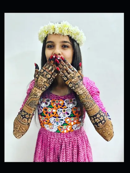 A playful moment with a happy bride. Her intricate mehndi design is the perfect accessory for her fun and festive spirit.