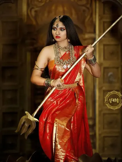 A full-length shot of the Devi look, showcasing the grandeur of the red saree and the complete set of our imitation temple jewellery.