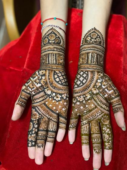A rich and dense bridal mehendi design. The pattern is filled with traditional Indian motifs, perfect for a bride who wants a very full and intricate look.