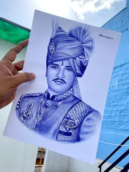 The finished blue pen portrait of Om Banna, held up against the blue walls of Jodhpur. This piece is a tribute to a figure deeply respected in my culture.