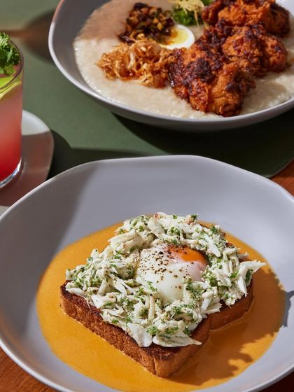 A beautiful serving of our Warm Crab Toast, showcasing the pile of fresh lump crab and the perfectly cooked egg.