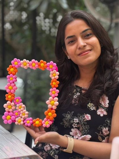 A beautifully crafted floral mirror, made with colorful clay. This participant is taking home a unique piece of decor. (Note: This is a repeat of ID 13, used to show a different angle/context).