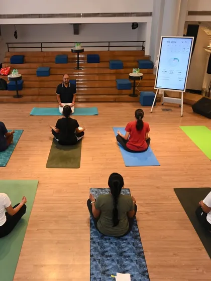 A moment of calm and focus during our on-site yoga session for Samsung India. We lead participants in Sukhasana (Easy Pose) with mindful breathing to help center the mind and prepare for a productive day, demonstrating how easily meditation can be integrated into the corporate environment.