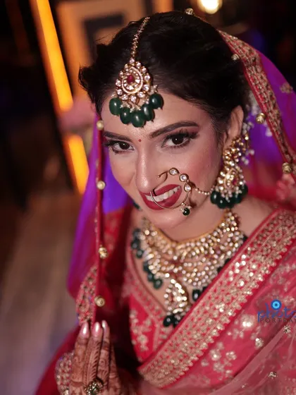 A classic smiling bridal portrait. We focus on capturing the bride's happiness and radiance, along with her beautiful makeup and jewelry.
