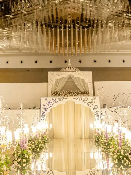 Our custom-built double-decker entrance for a grand reception. As dancers performed on the top level, a three-layered curtain parted to reveal the couple, who then descended in a lift to a mirrored walkway.