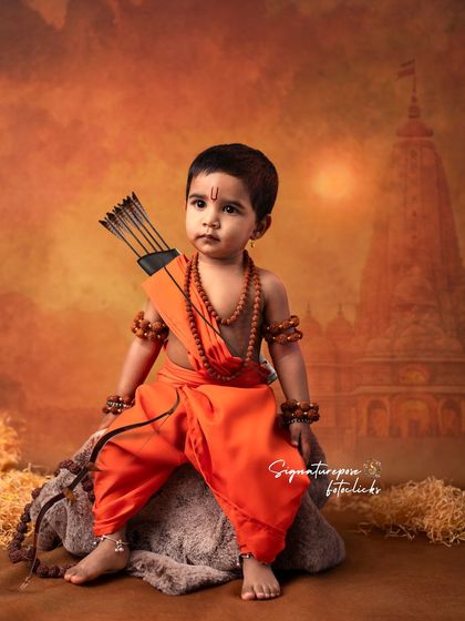 The innocent yet powerful gaze of a child dressed as Lord Rama, highlighting the detailed costuming and props we provide.