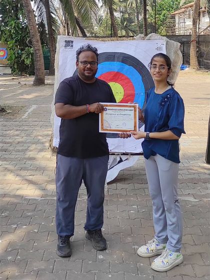 This student from the April 2024 batch proudly holds her certificate. It's a great achievement for any new archer.