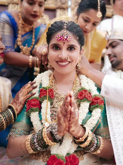The heart of a South Indian wedding is in its traditions and family blessings. This candid shot captures the bride's joyful expression and the warmth of her loved ones, a moment of pure, unscripted happiness.