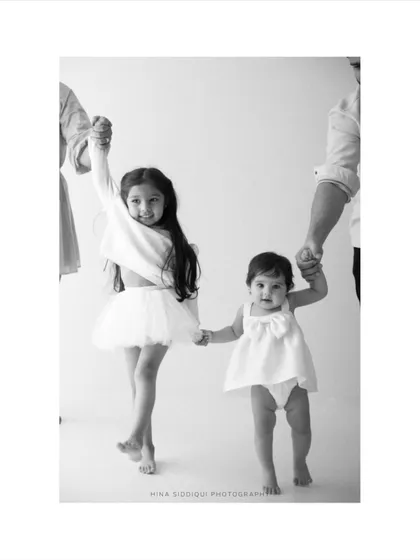 The bond between siblings is a story I love to tell. This timeless black and white family portrait captures that pure, unscripted connection as two sisters walk hand in hand, creating a memory of their shared childhood.