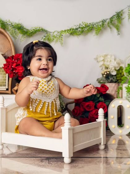 A bright, happy smile from the birthday girl. She changed into a sunny yellow outfit for another look during her versatile first birthday session.