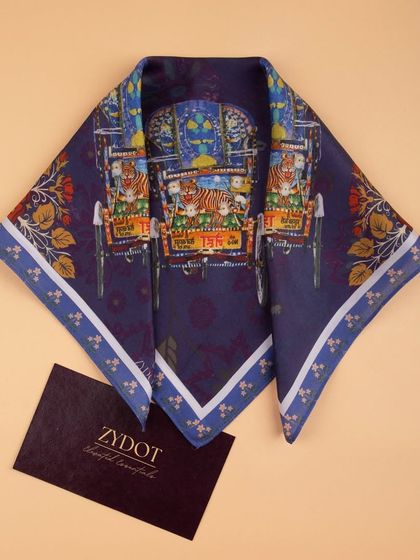 The auto-rickshaw print pocket square creatively folded to highlight the central design elements.