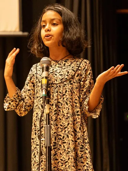 A young performer delivering a monologue in 'The Emperor's New Clothes'. This demonstrates the confidence required to hold the stage alone and deliver lines with clarity and expression.