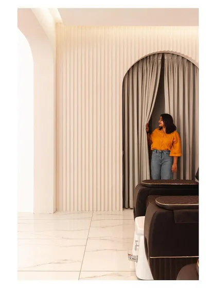 Arches and fluted panels are recurring motifs in the 'Frumos' salon, used here to create a soft, inviting entrance to a more private service area.