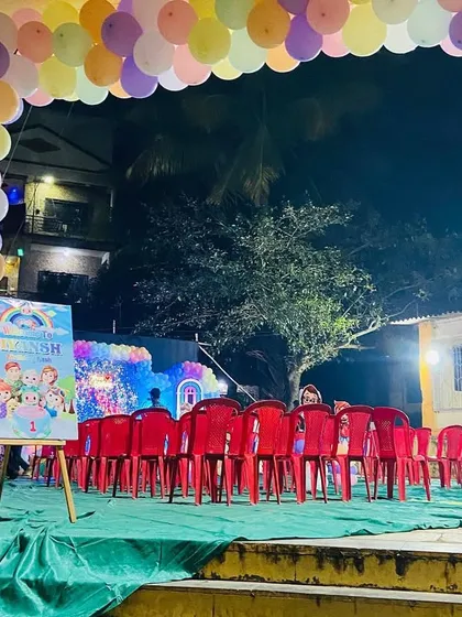 The view from the entrance of a Cocomelon party, showing the seating arrangement facing the decorated stage and a welcome sign.