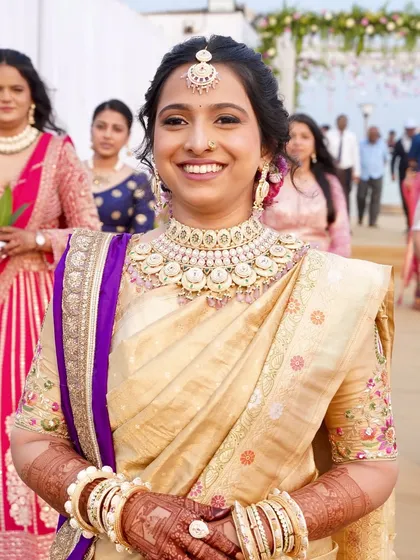 A radiant Marathi bride ready for her seaside wedding. This monochromatic look with a dash of color on the lips was designed to glow against the backdrop of the Arabian Sea, especially during the sunset sindoor ceremony.