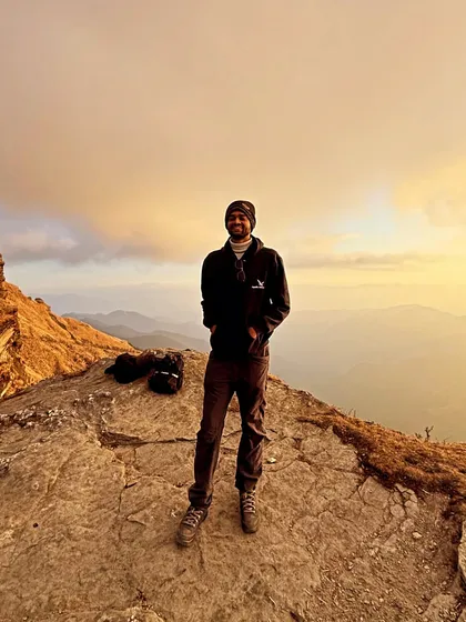 Chasing sunsets and adventures. A candid shot of our trip captain soaking in the golden hour from a mountain top near Chopta.