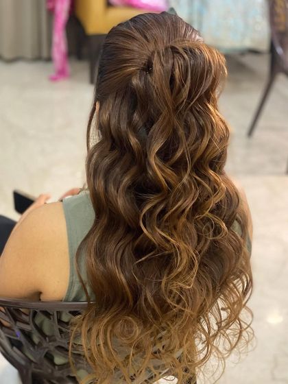 Messy waves in a half-up style. This is a relaxed, bohemian look that is perfect for a casual event or a pre-wedding party.