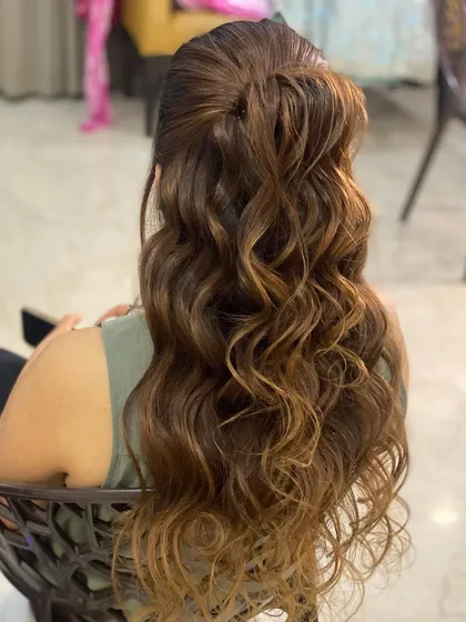 Messy waves in a half-up style. This is a relaxed, bohemian look that is perfect for a casual event or a pre-wedding party.