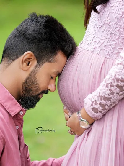 An intimate close-up of a father-to-be resting his head on the baby bump, a beautiful way to show connection.