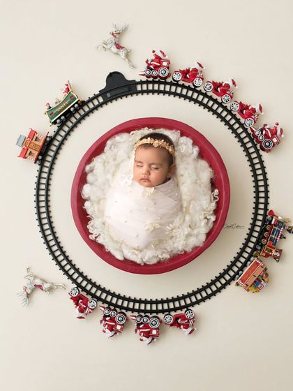 All aboard the Christmas express. This creative flat-lay shot uses a toy train track to create a whimsical and festive holiday scene.